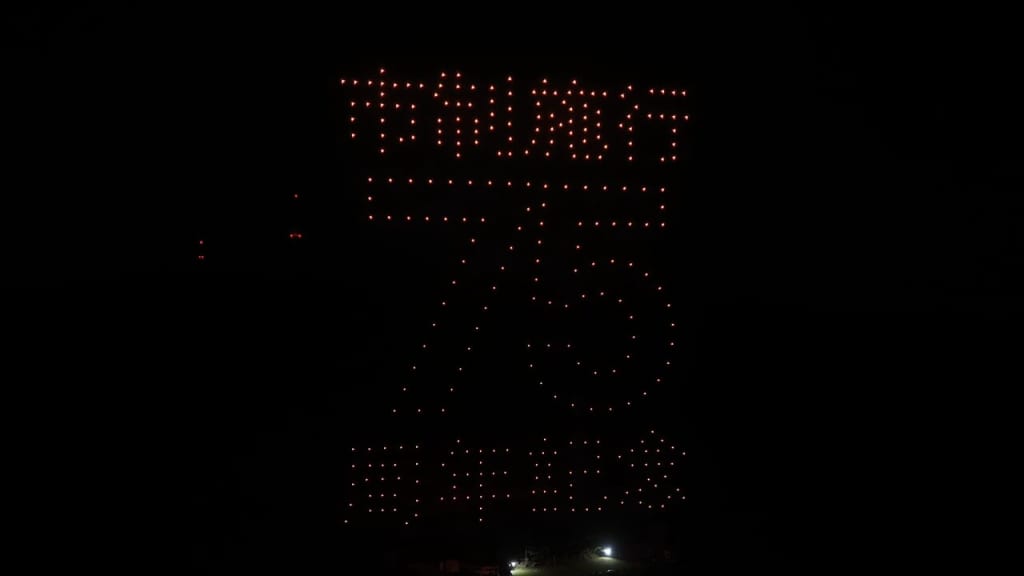 Tall vertical LED sign at night; red dots form the word 'THANKS' with a circular dot pattern beneath on a dark sky.